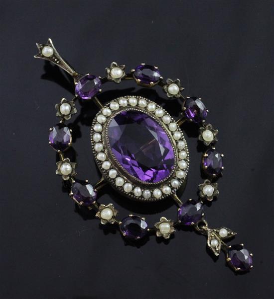 An Edwardian gold, amethyst and seed pearl set oval drop pendant brooch, overall 2.25in.